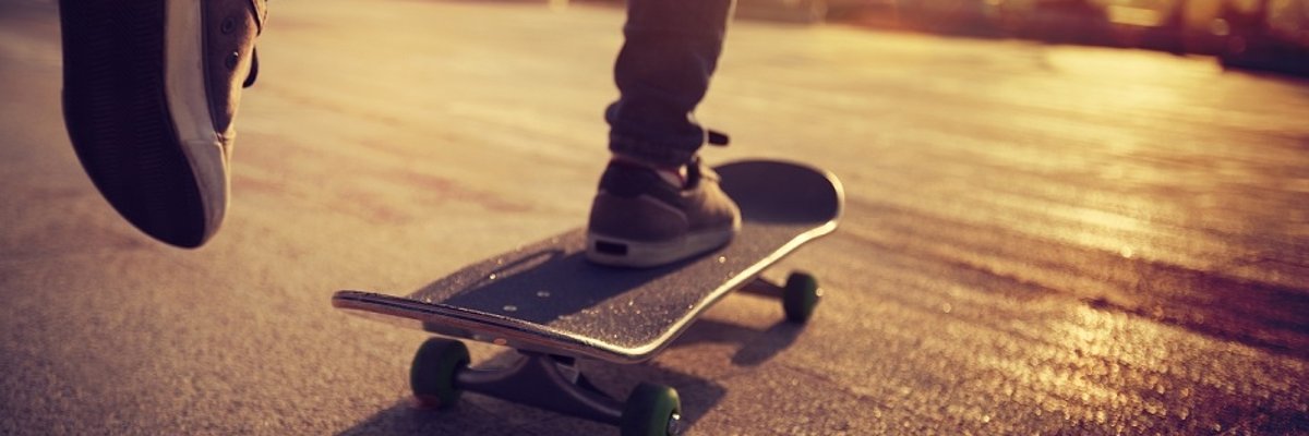 Skateboarder skateboarding at sunrise city