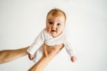 Father hands holding infant baby family lifestyle dad and child parenthood concept 3 month old kid Father hands holding infant baby family lifestyle dad and child parenthood concept 3 month old kid