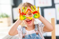 funny child girl draws laughing shows hands dirty with paint funny child girl draws laughing shows hands dirty with paint
