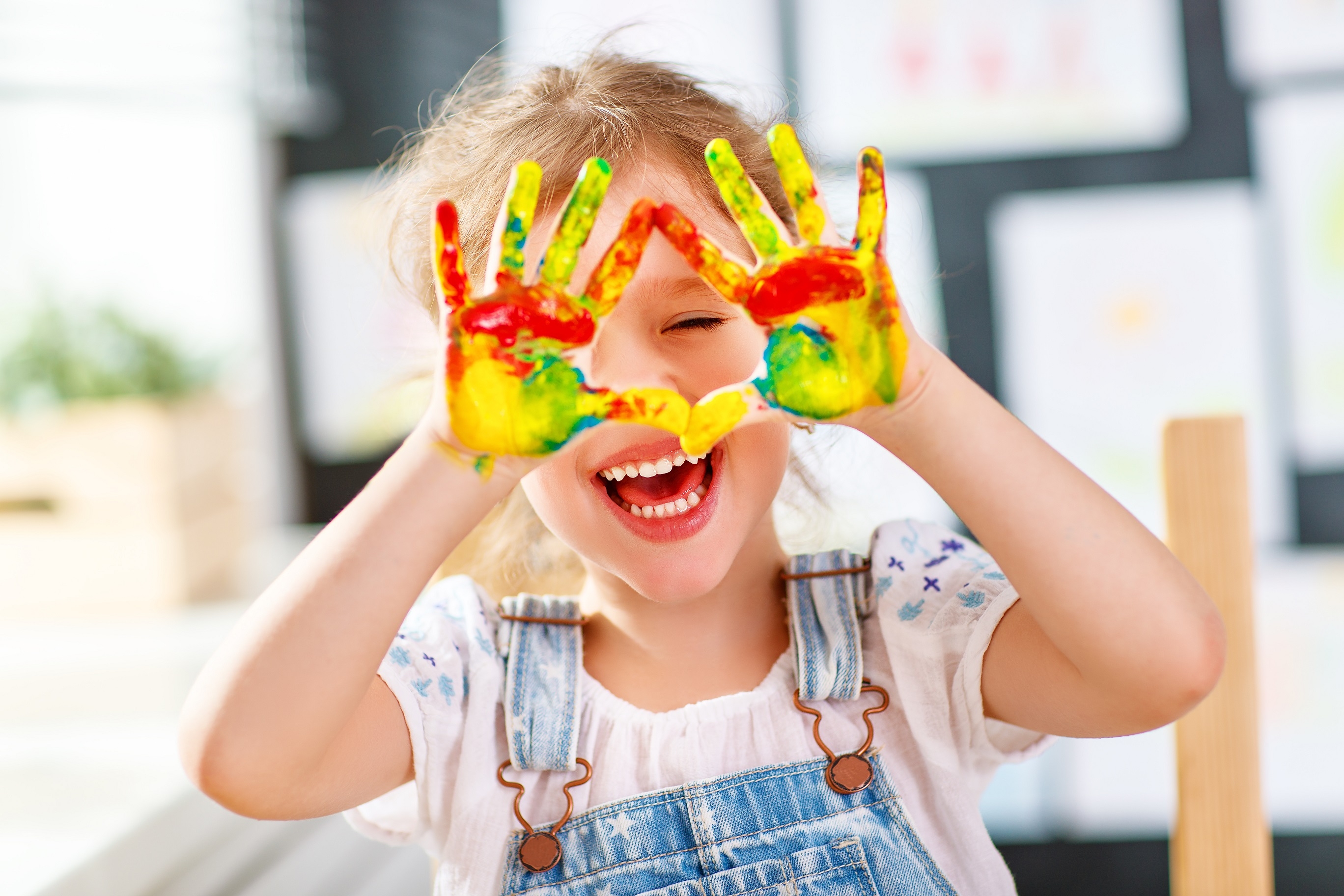funny child girl draws laughing shows hands dirty with paint funny child girl draws laughing shows hands dirty with paint
