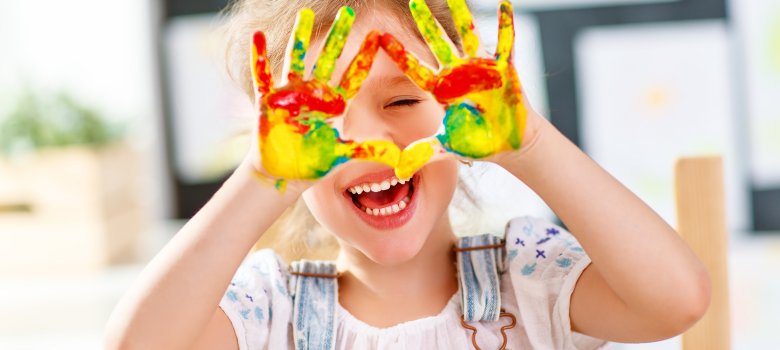funny child girl draws laughing shows hands dirty with paint funny child girl draws laughing shows hands dirty with paint