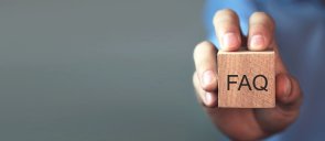 Man holding FAQ message on wooden cube. Frequently Asked Questions Man holding FAQ message on wooden cube. Frequently Asked Questions
