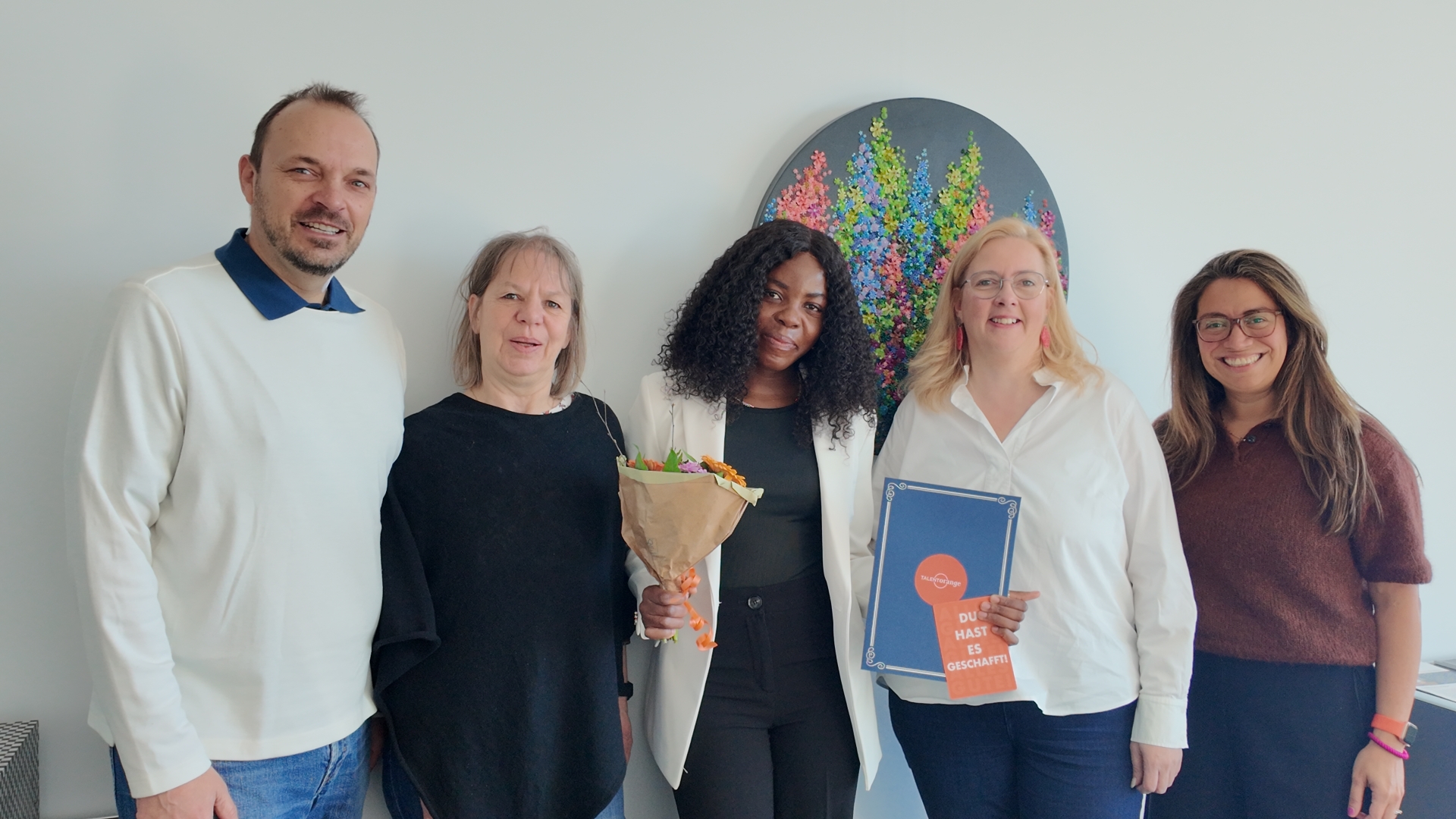 „Eine pädagogische Fachkraft aus Namibia erhält im Beisein von Verwaltungsvertreterinnen ihre Anerkennungsurkunde im Rahmen einer feierlichen Veranstaltung.